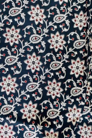 Navy blue cotton fabric with floral block print in white and red accents, soft breathable texture – ideal for ethnic and casual wear outfits (unstitched material).